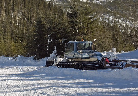 A trail groomer used to pack snowmobile trails from valley bottoms up into subalpine winter caribou habitat